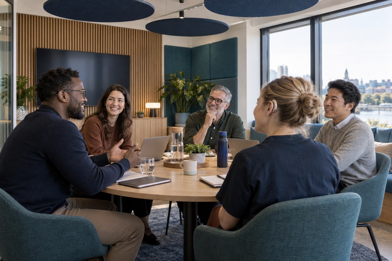 Inclusive team meeting in a room designed with acoustic panels and clear sightlines